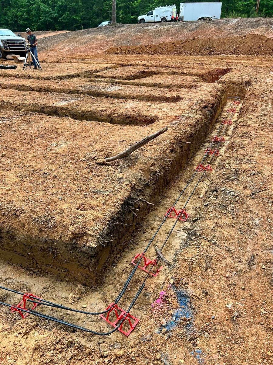 Footings dug in red clay with rebar set