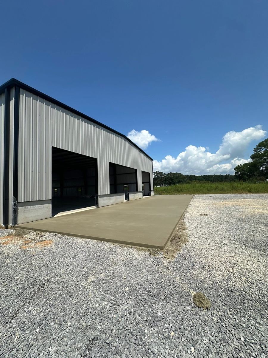 A steel building with a fresh concrete apron